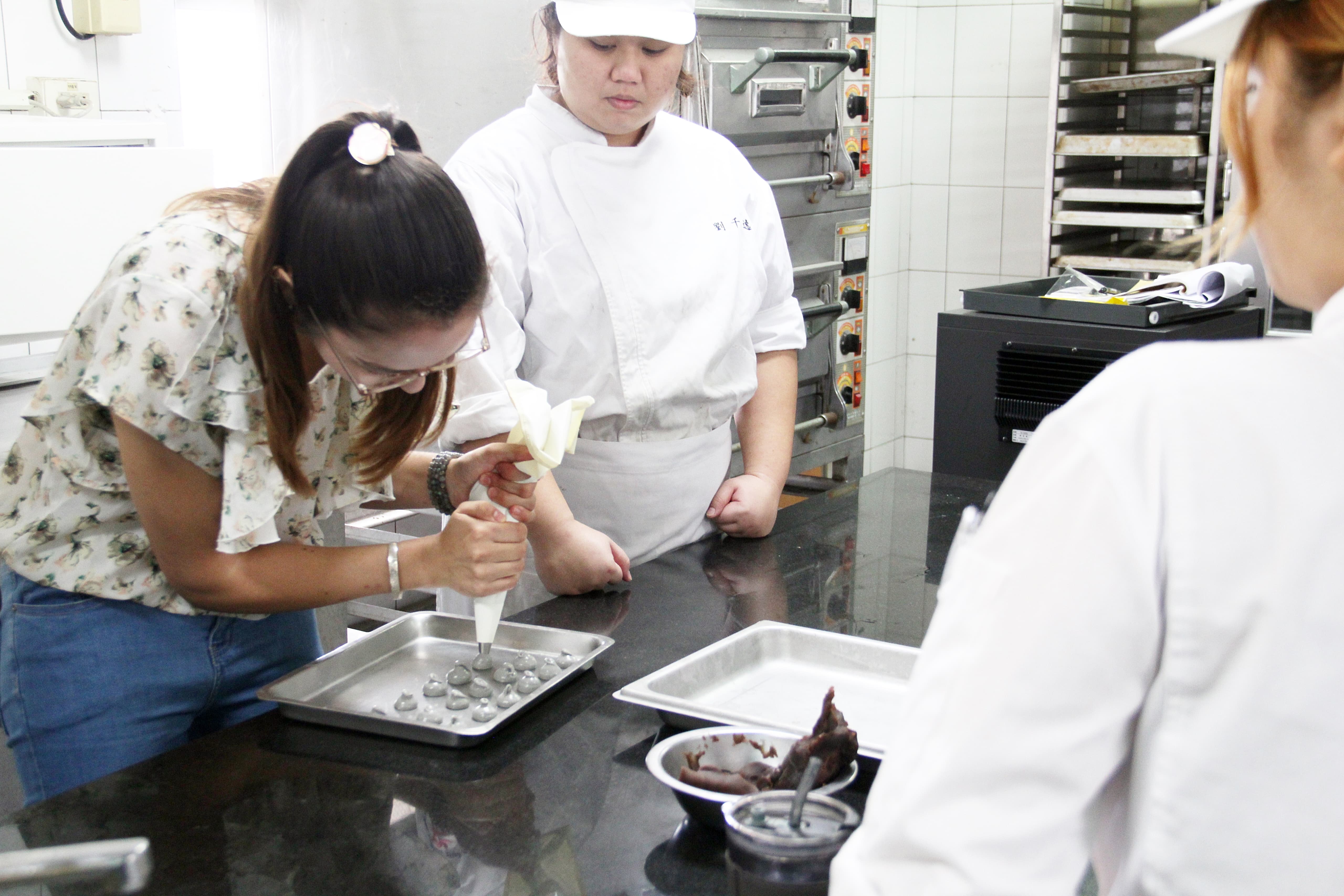 Piping black sesame ganache for daifuku.
